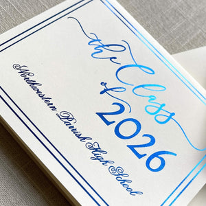 Graduation announcement card with blue foil design for 'the Class of 2026' on a gray textured background.
