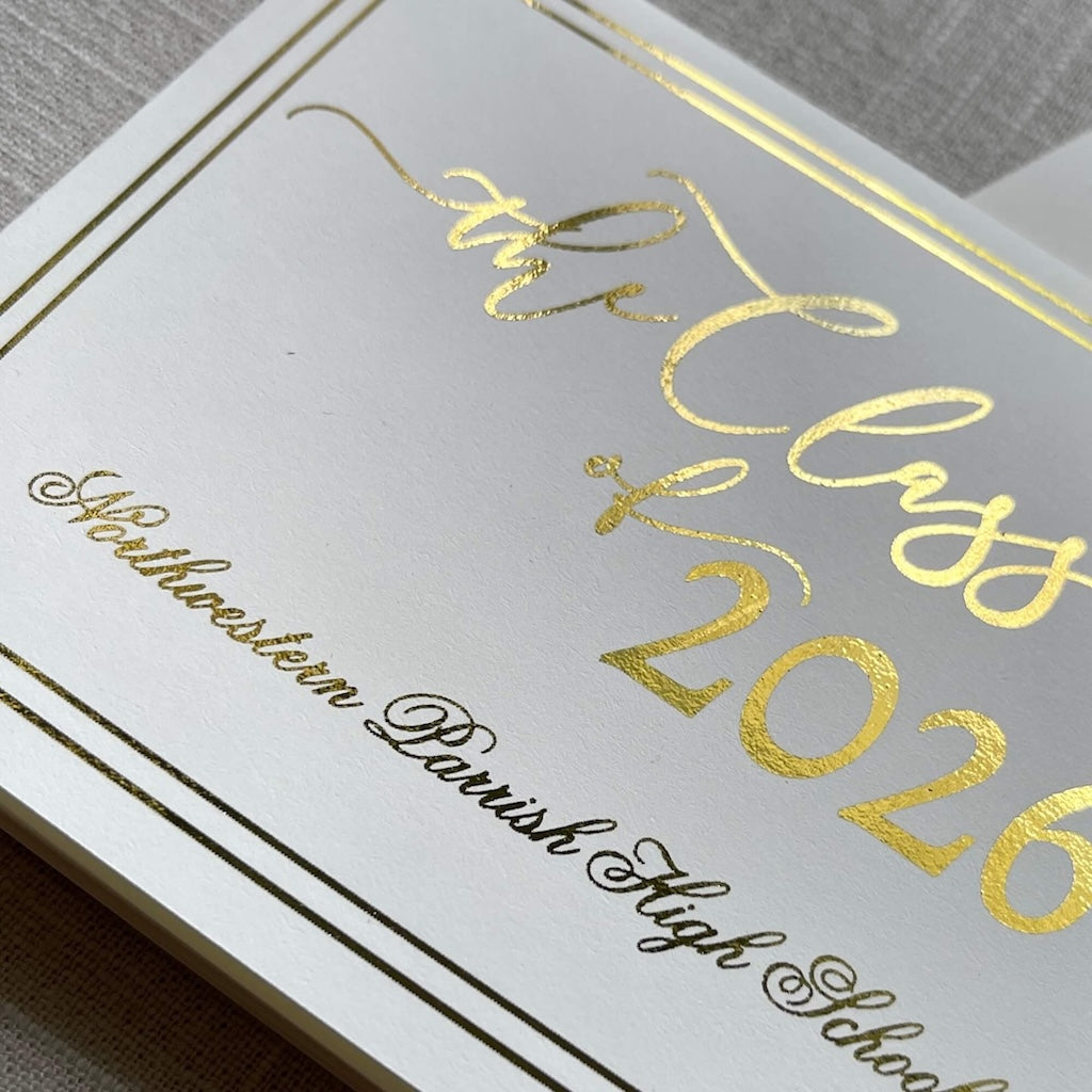 Graduation announcement card with gold foil design for 'the Class of 2026' and an envelope on a gray textured background.