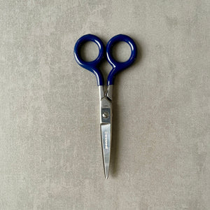 'Penco' brand pair of scissors with blue handles on a gray background