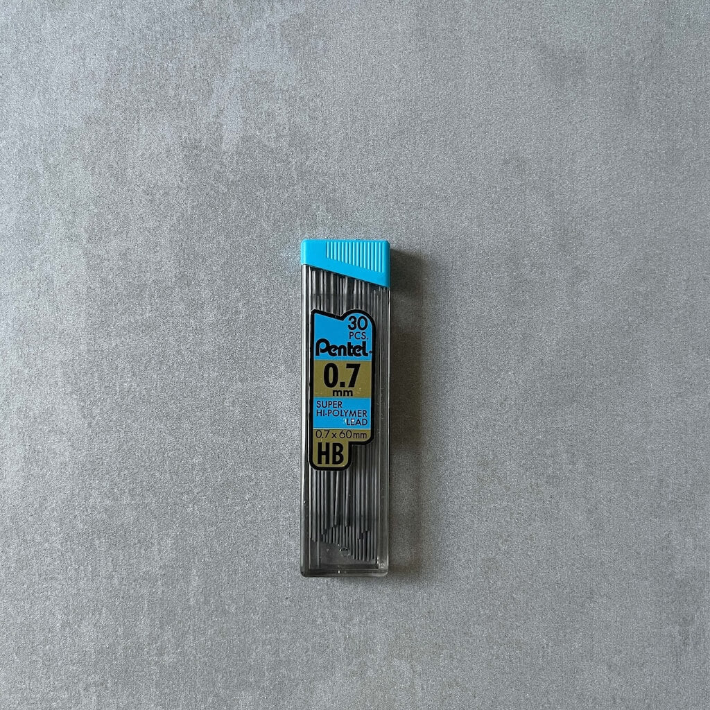 Pentel 0.7mm pencil lead refills in holder with blue top on a gray background