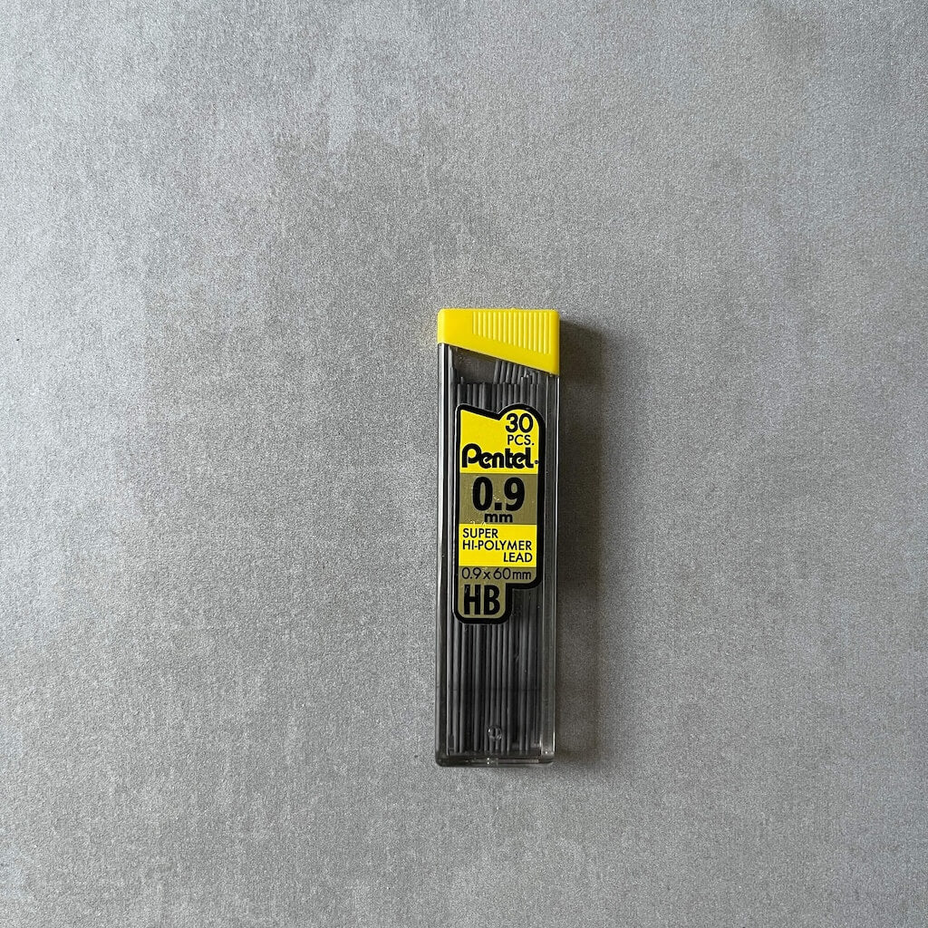 Pentel 0.9mm pencil lead refills in holder with yellow top on a gray background