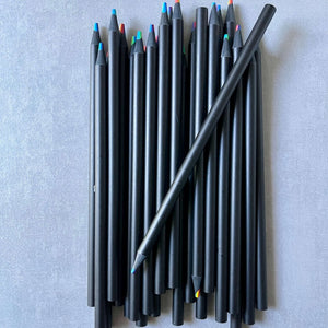 Set of black colored pencils with colorful tips on a gray background