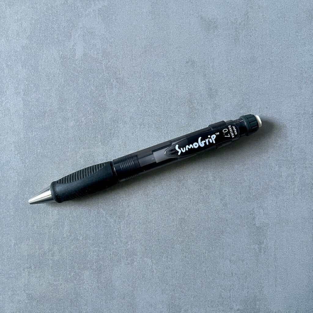 SumoGrip brand 0.7 mm black mechanical pencil on a gray background