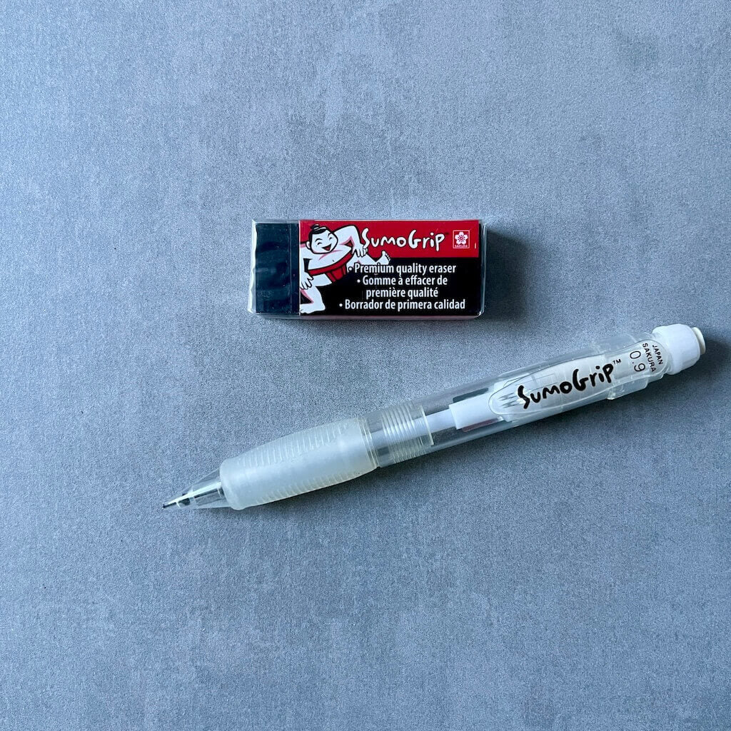 SumoGrip mechanical pencil and block eraser on a gray surface